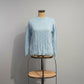Light blue cotton sweater with cable knit pattern
