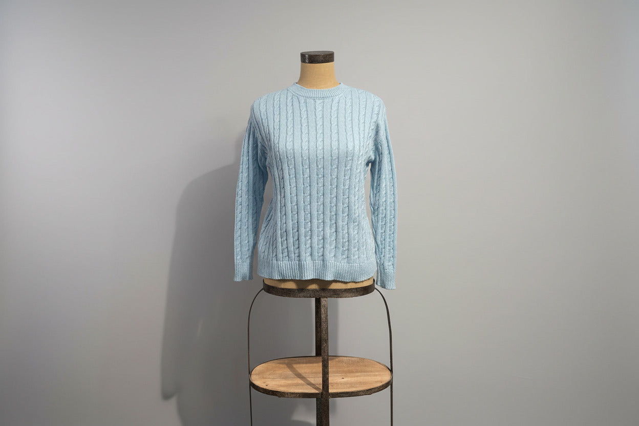 Light blue cotton sweater with cable knit pattern