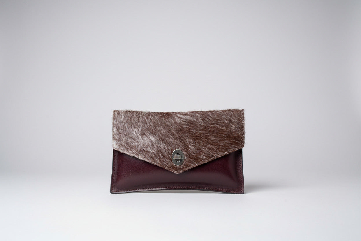 handmade burgundy leather clutch with cowhide and metal clasp