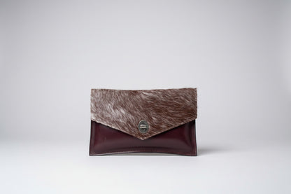 handmade burgundy leather clutch with cowhide and metal clasp