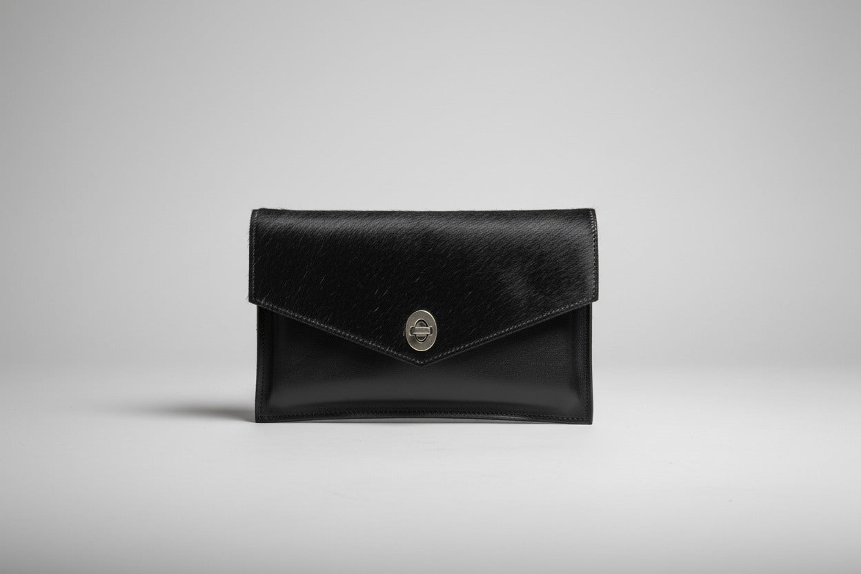 hanadmade Black leather clutch with a turn lock closure and hair-on cowhide in black