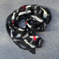 Silk scarf with black, white, and red pattern in merino wool